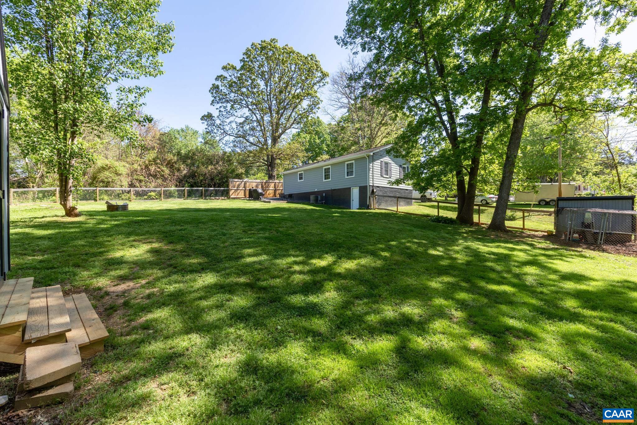 100 Holmes Run Road Stanardsville, VA 22973 - Photo 20 of 22 a backyard of a house with table and chairs