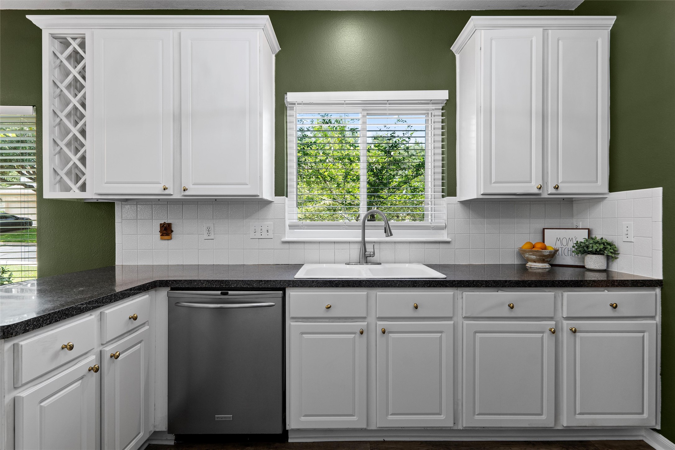 7000 Colberg Court Austin, TX 78749 - Photo 16 of 40 A well-appointed kitchen features white cabinetry and sleek stainless steel appliances.