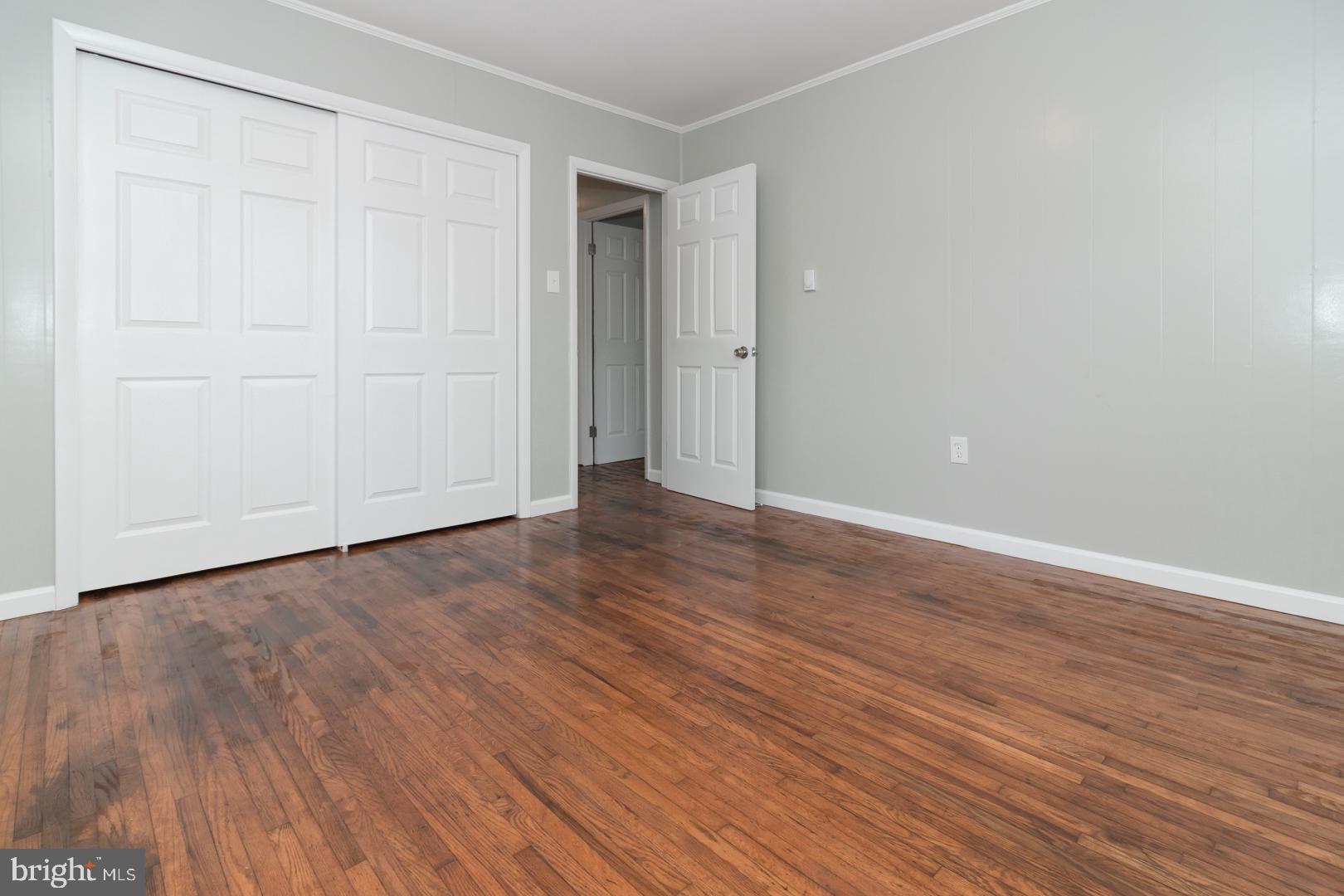 320 Fenwick Road Pilesgrove, NJ 08098 - Photo 15 of 18 a view of an empty room with wooden floor