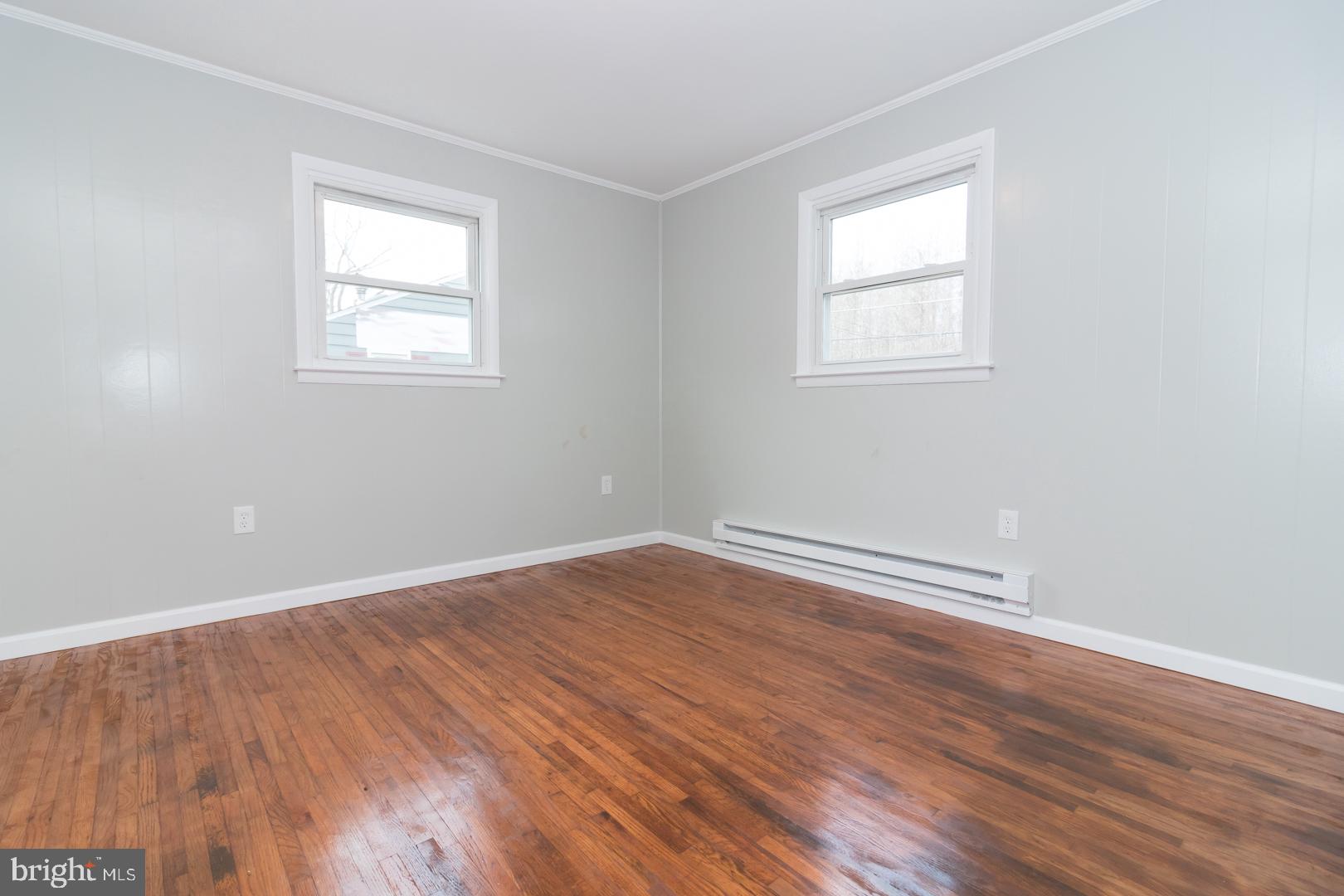 320 Fenwick Road Pilesgrove, NJ 08098 - Photo 16 of 18 an empty room with wooden floor and windows