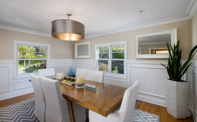 a dining room with furniture and window