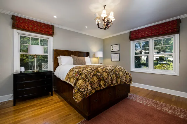 a bed sitting in a bedroom next to a window