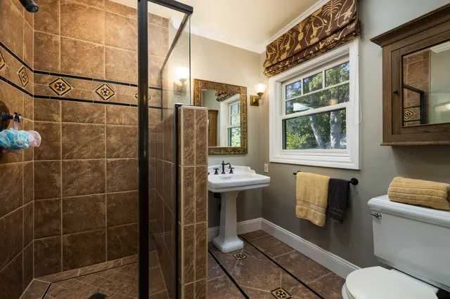 a bathroom with a sink toilet and shower