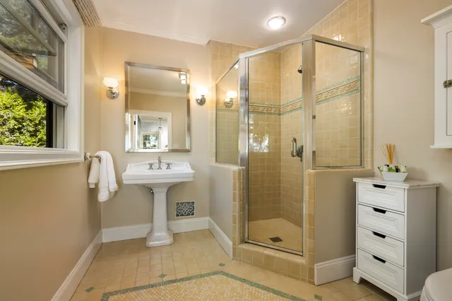 a bathroom with a shower sink and mirror