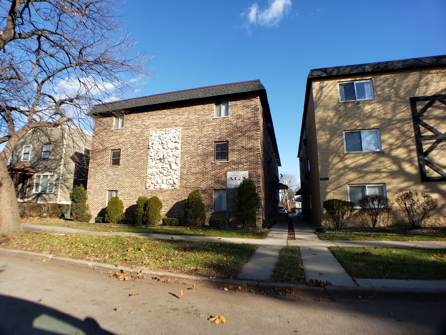 1124 Dunlop Avenue, Unit 2C Forest Park, IL 60130 - Photo 1 of 25 a front view of building with cars parked