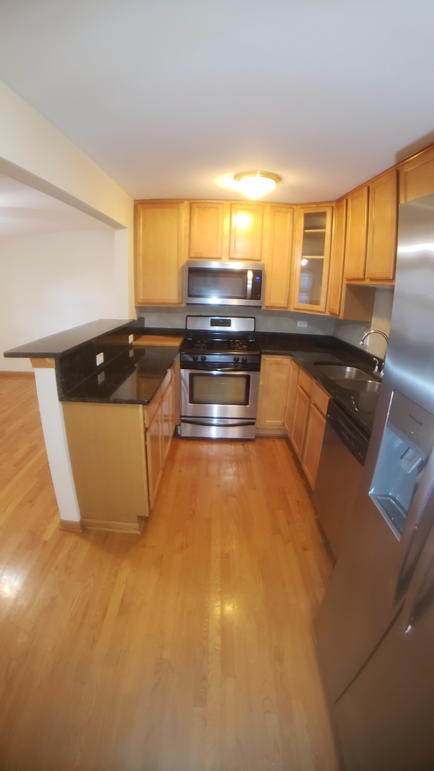 1124 Dunlop Avenue, Unit 2C Forest Park, IL 60130 - Photo 12 of 25 a kitchen with a stove and a refrigerator