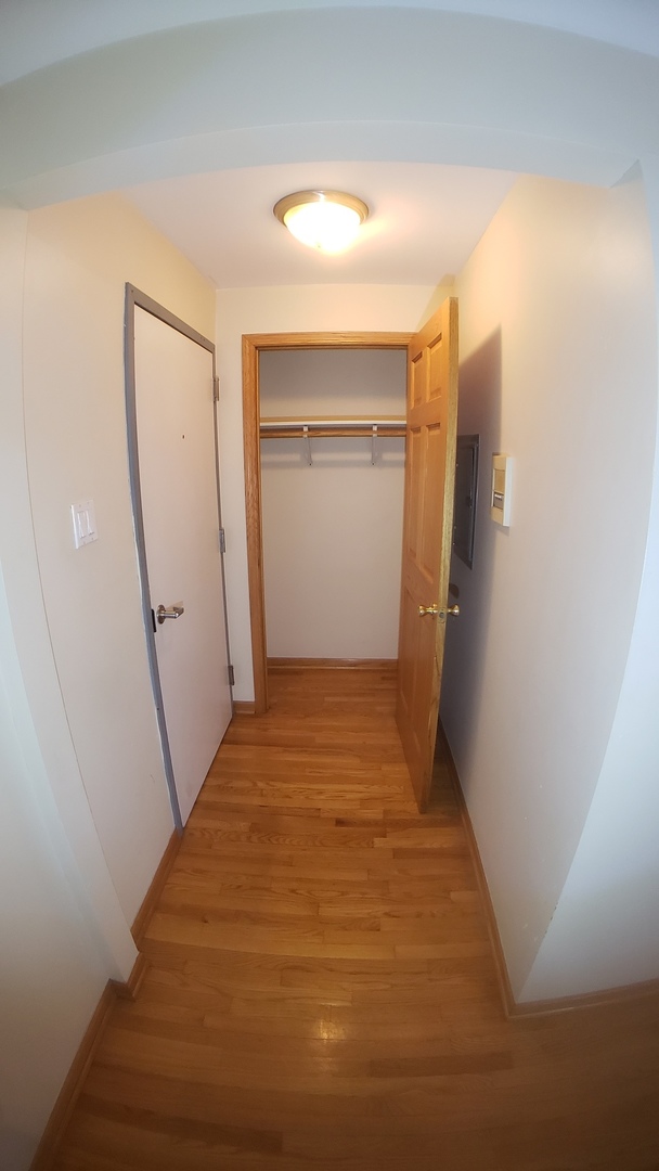 1124 Dunlop Avenue, Unit 2C Forest Park, IL 60130 - Photo 6 of 25 a view of a hallway view with wooden floor and staircase