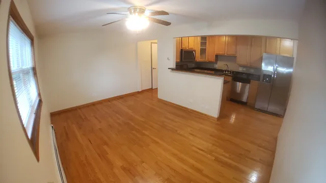 a kitchen with stainless steel appliances granite countertop a refrigerator a sink and a stove