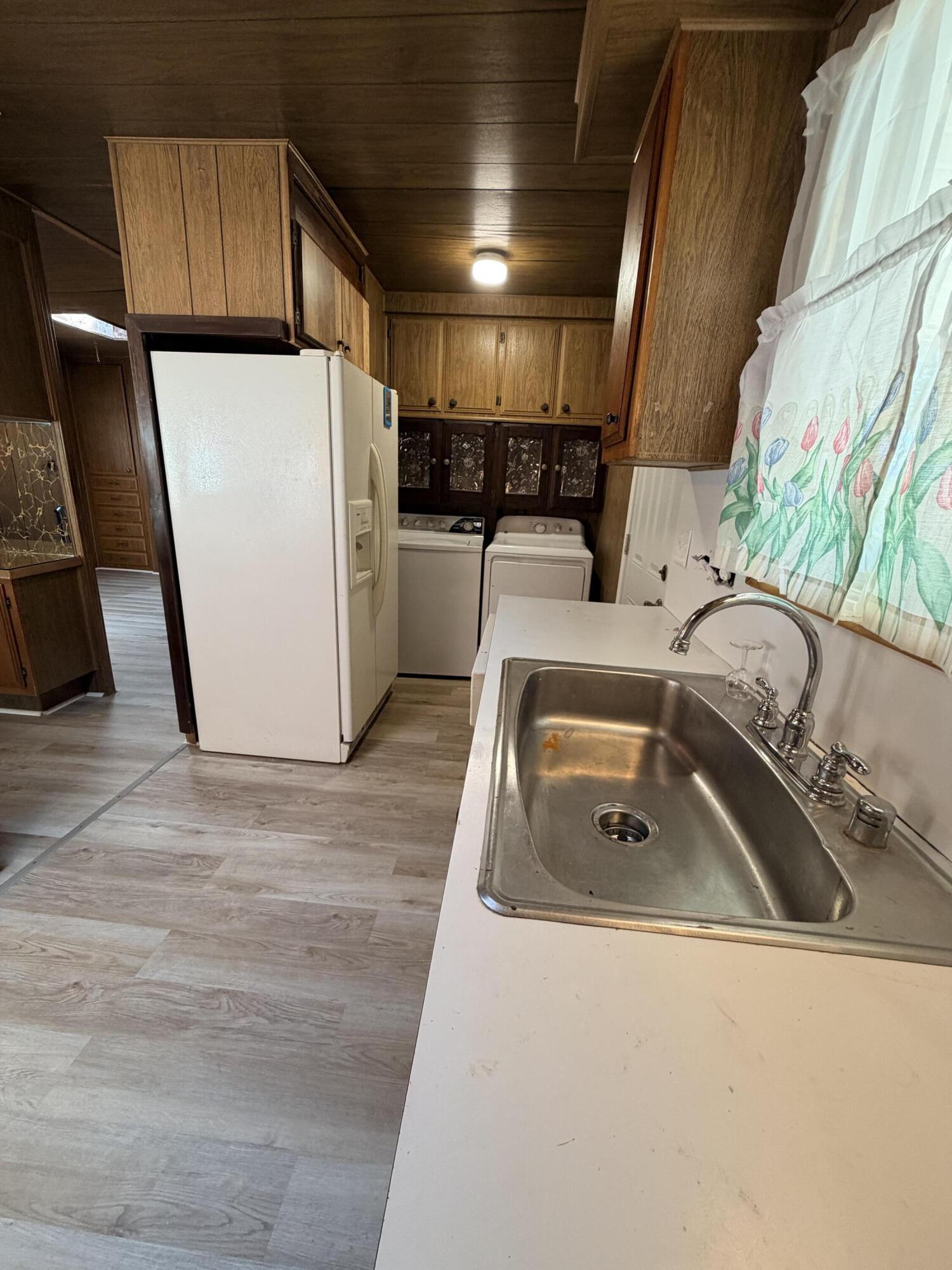 1449 Menomenee Lane, Unit 252 Redding, CA 96003 - Photo 7 of 18 a kitchen with a sink a refrigerator and a stove