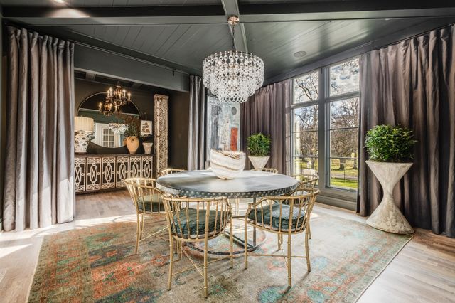 a dining room with furniture and a clock