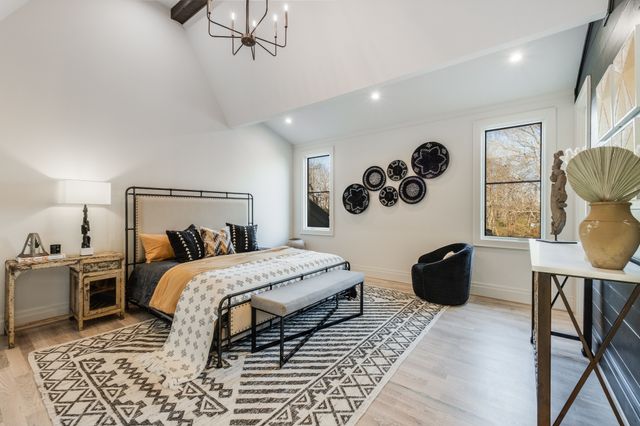 a bedroom with a bed couch and dresser