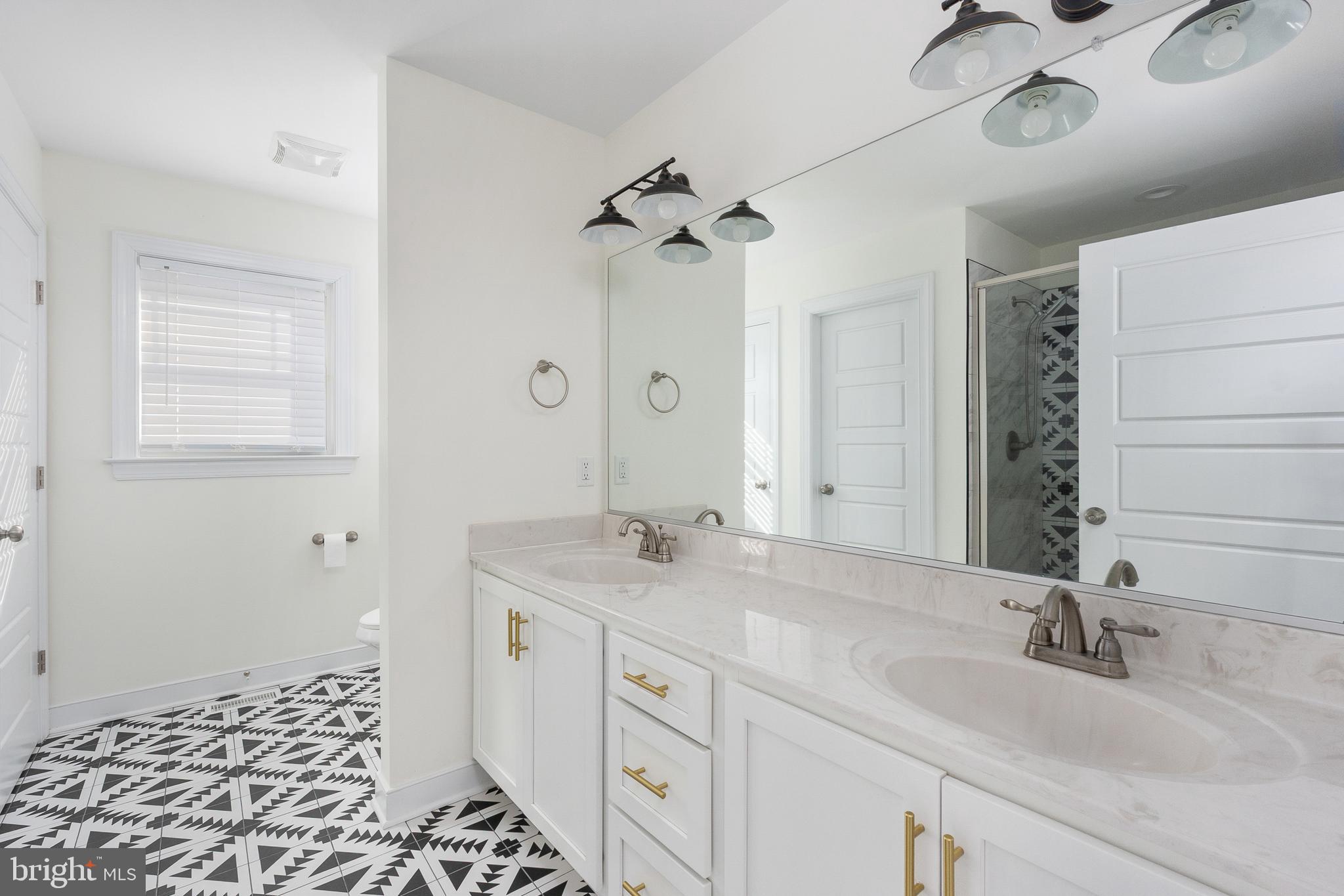 600 Signboard Road Bumpass, VA 23024 - Photo 29 of 49 a bathroom with a granite countertop sink a mirror and a shower