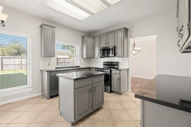 a kitchen with a sink stove and refrigerator