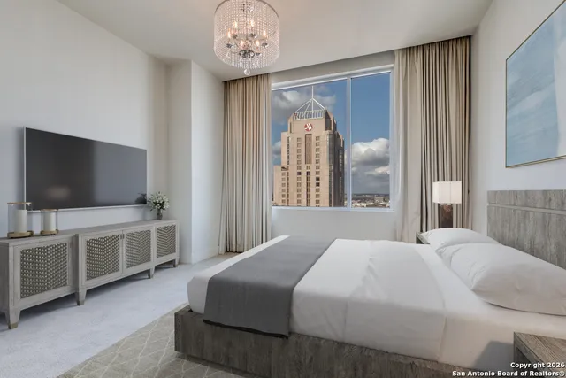 a bedroom with a bed and a flat tv screen on dresser