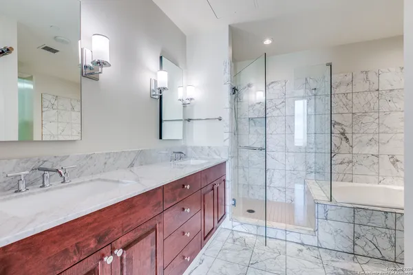 a bathroom with a granite countertop sink mirror and shower