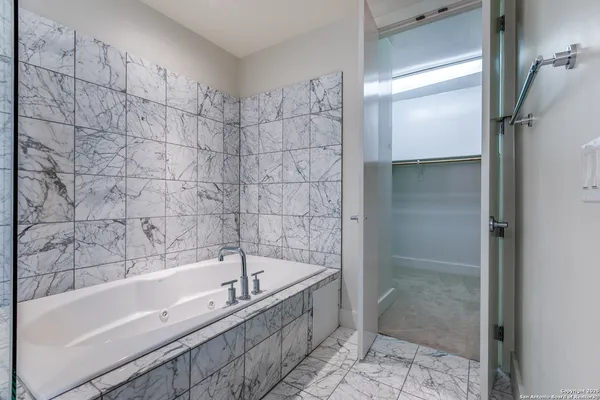 a bathroom with a bathtub and shower