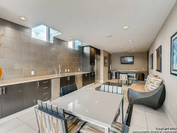 a large kitchen with a table and chairs