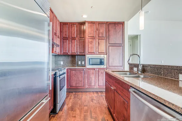 a kitchen with a sink stove and cabinets