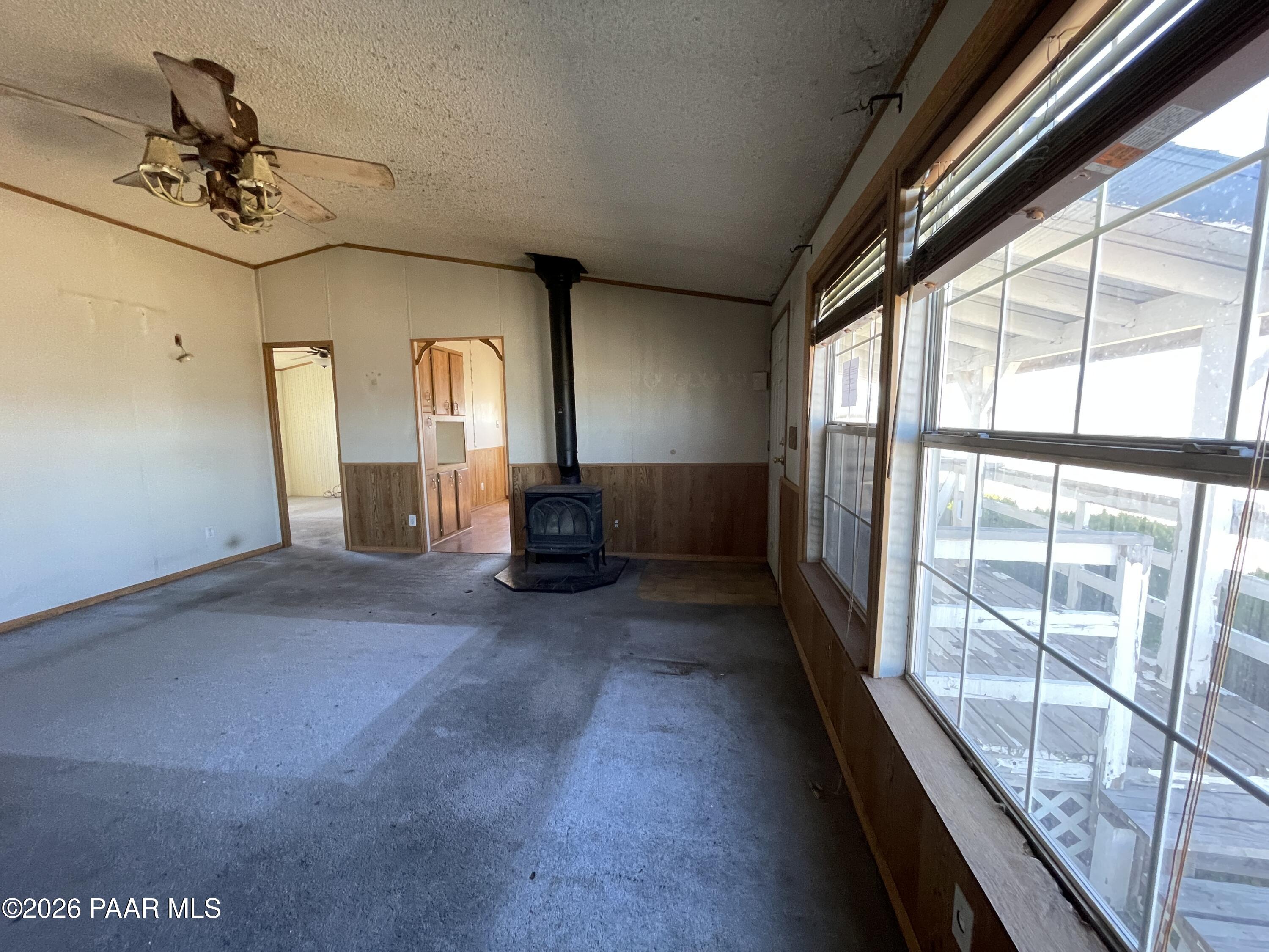 1355 South Reed Road Chino Valley, AZ 86323 - Photo 12 of 35 a view of empty room with a floor to ceiling window and a ceiling fan
