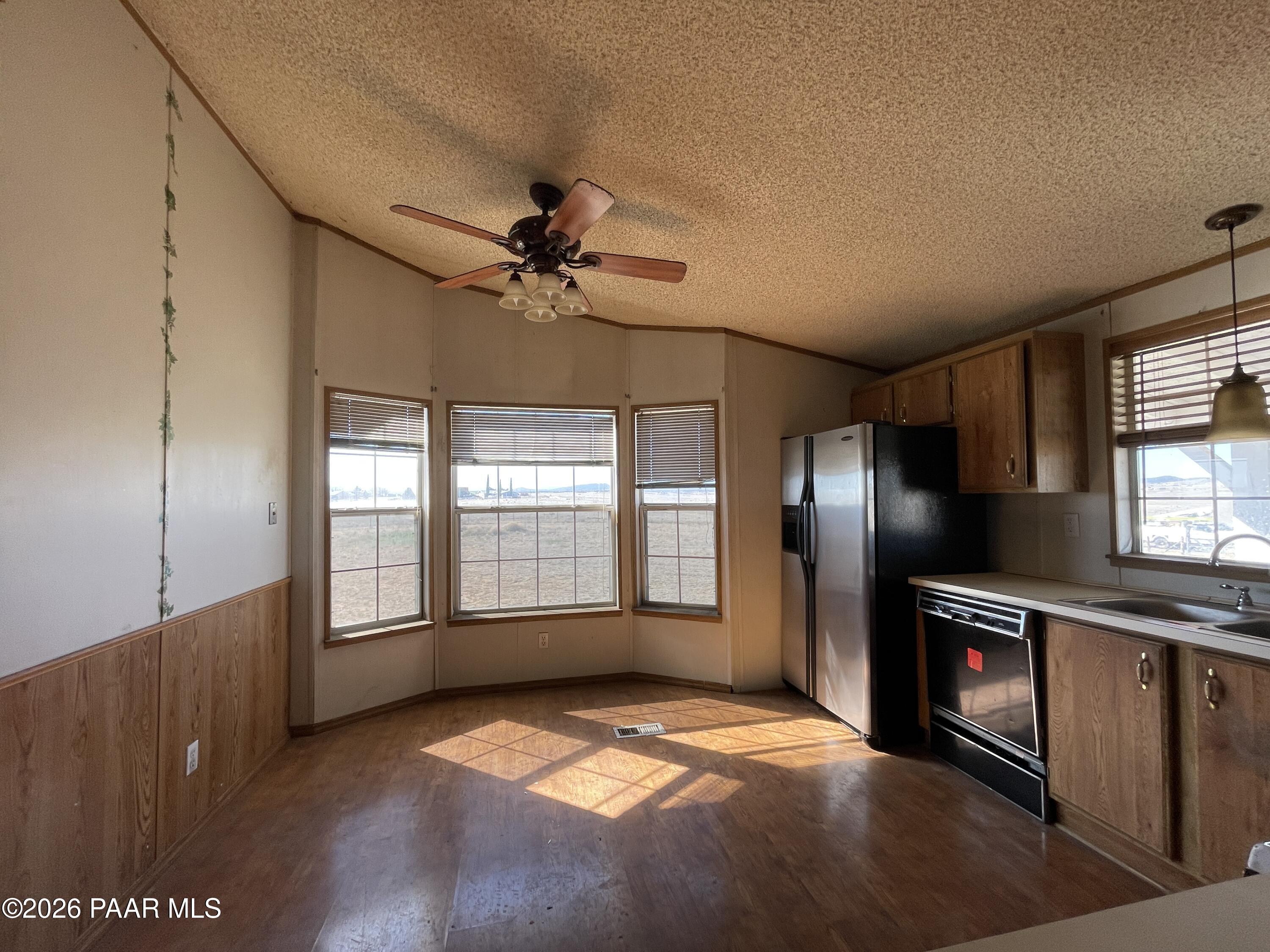 1355 South Reed Road Chino Valley, AZ 86323 - Photo 13 of 35 a view of a refrigerator in kitchen and windows