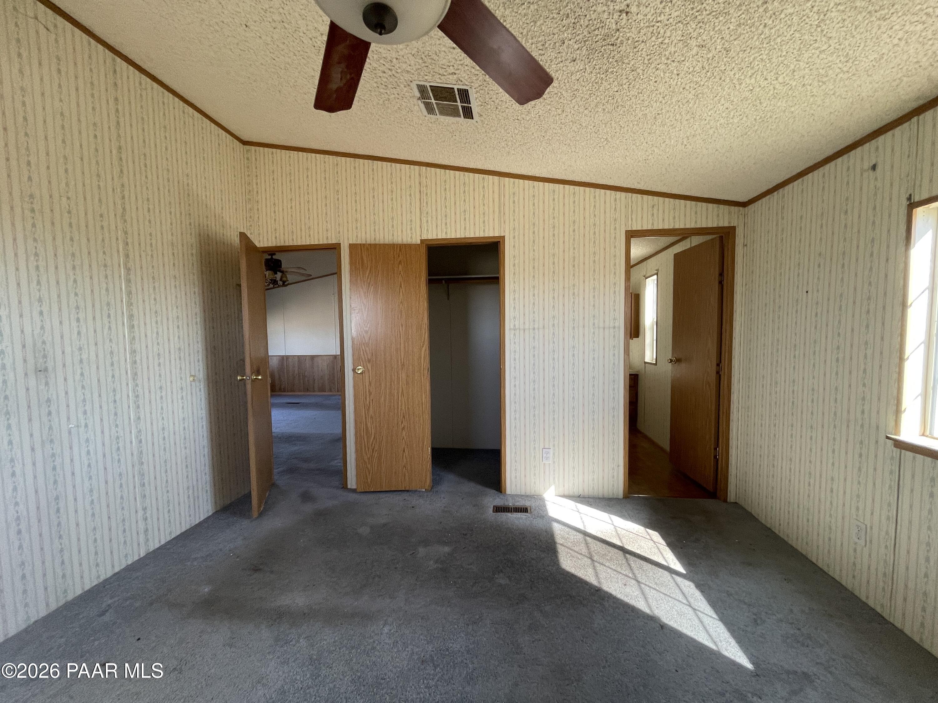 1355 South Reed Road Chino Valley, AZ 86323 - Photo 17 of 35 a view of a hallway with wooden walls