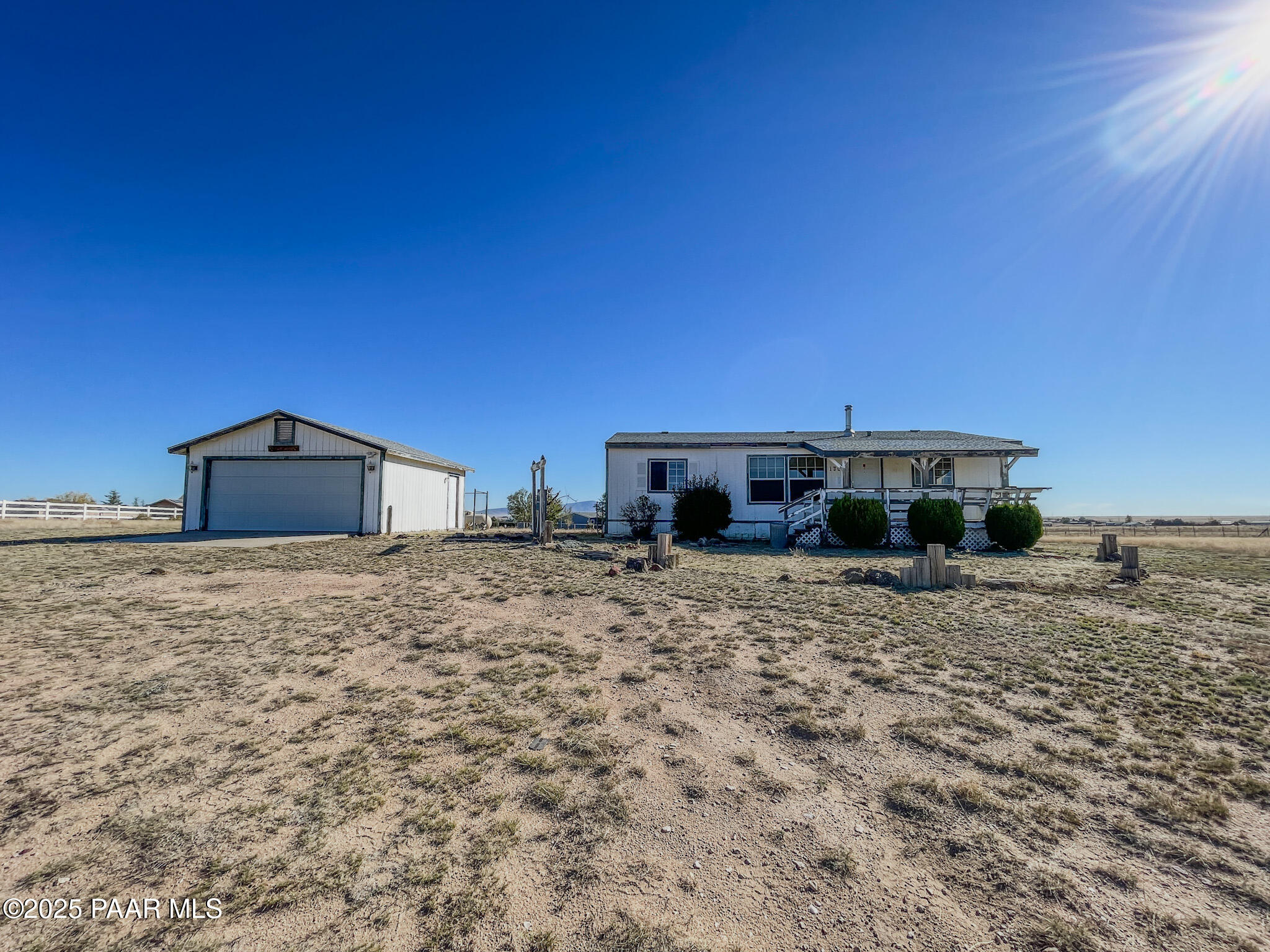 1355 South Reed Road Chino Valley, AZ 86323 - Photo 2 of 35 a view of a house with backyard and trees