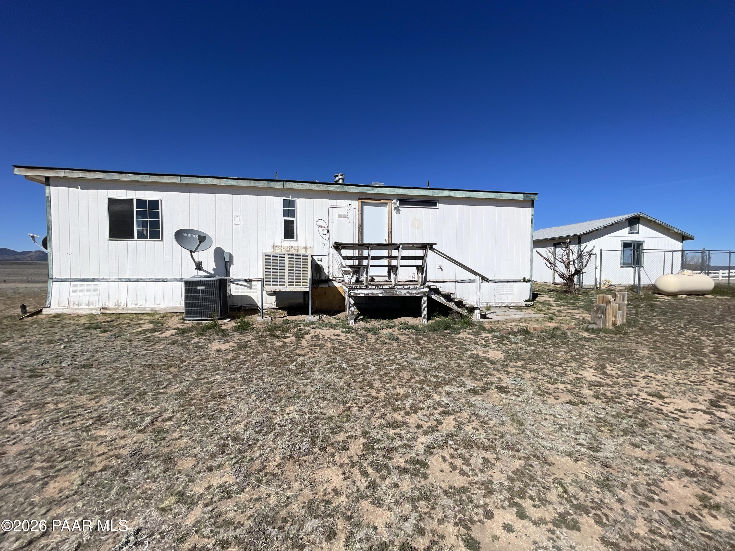 1355 South Reed Road Chino Valley, AZ 86323 - Photo 31 of 35 a view of a house with backyard and a chair
