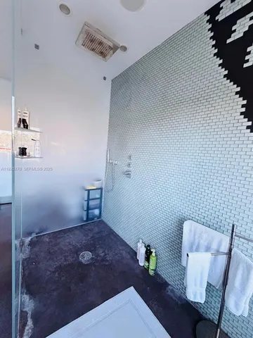 a bathroom with a toilet and a mirror