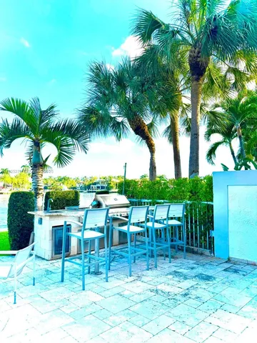 a view of a chairs and table in a backyard