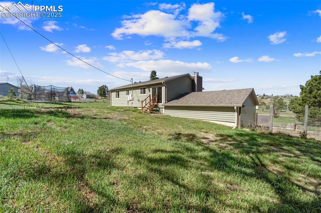 1151 Buttercup Road Elizabeth, CO 80107 - Photo 18 of 45 a view of a big yard with potted plants