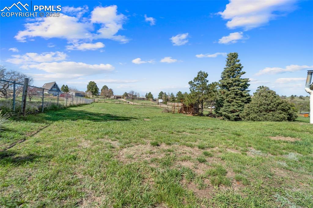 1151 Buttercup Road Elizabeth, CO 80107 - Photo 20 of 45 a view of a field with an trees in the background