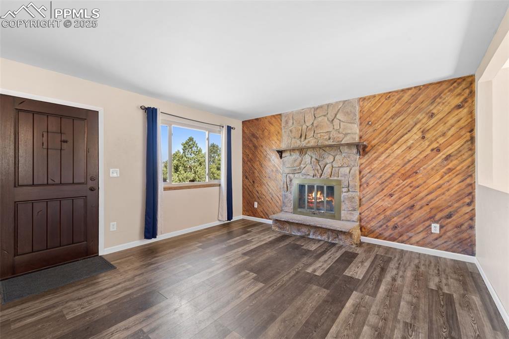 1151 Buttercup Road Elizabeth, CO 80107 - Photo 23 of 45 a view of an empty room with wooden floor and a window