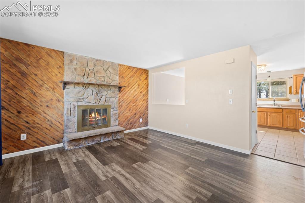 1151 Buttercup Road Elizabeth, CO 80107 - Photo 24 of 45 a view of an empty room with a fireplace and a window