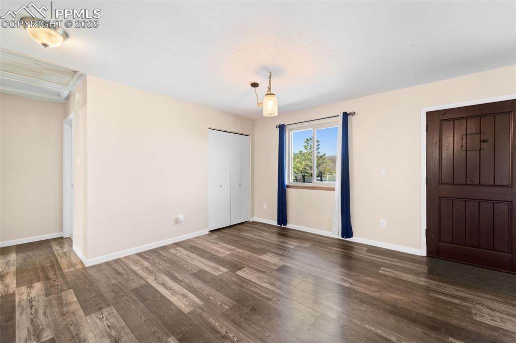 1151 Buttercup Road Elizabeth, CO 80107 - Photo 25 of 45 a view of an empty room with wooden floor and a window
