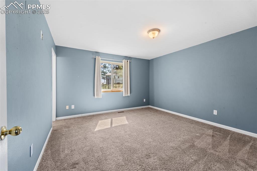 1151 Buttercup Road Elizabeth, CO 80107 - Photo 28 of 45 an empty room with windows and closet