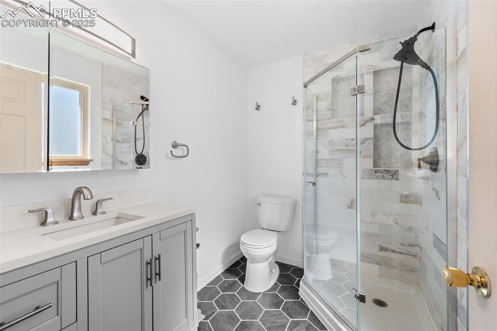 1151 Buttercup Road Elizabeth, CO 80107 - Photo 30 of 45 a bathroom with a shower sink mirror and toilet