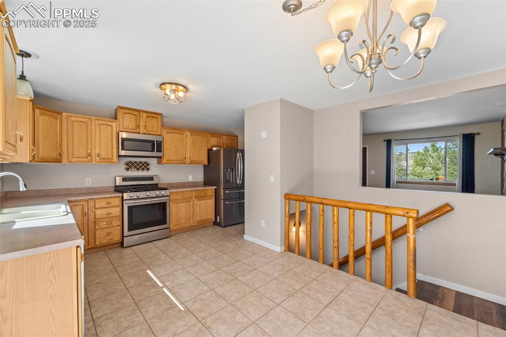 1151 Buttercup Road Elizabeth, CO 80107 - Photo 33 of 45 a kitchen with stainless steel appliances granite countertop a refrigerator a stove top oven a sink and dishwasher