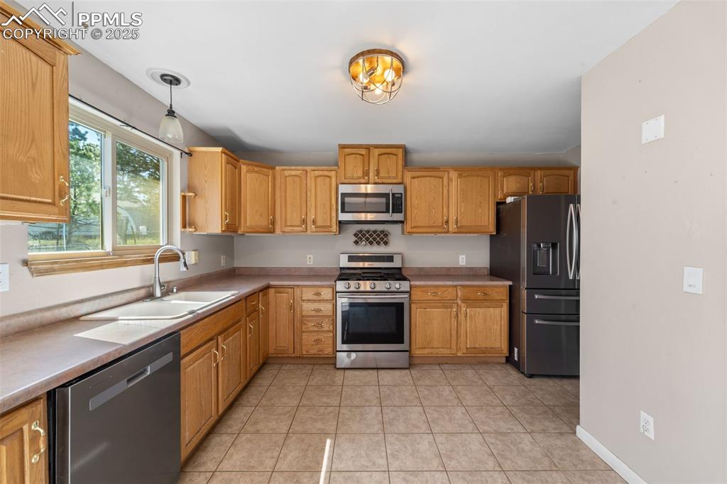 1151 Buttercup Road Elizabeth, CO 80107 - Photo 34 of 45 a kitchen with a stove top oven sink and cabinets