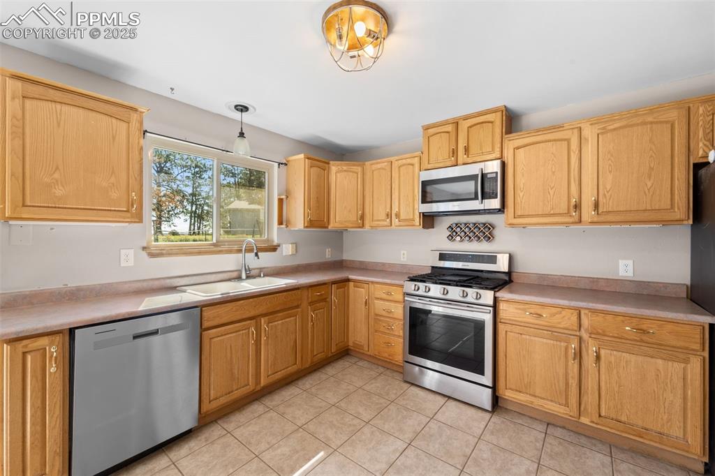 1151 Buttercup Road Elizabeth, CO 80107 - Photo 35 of 45 a kitchen with cabinets appliances and a window
