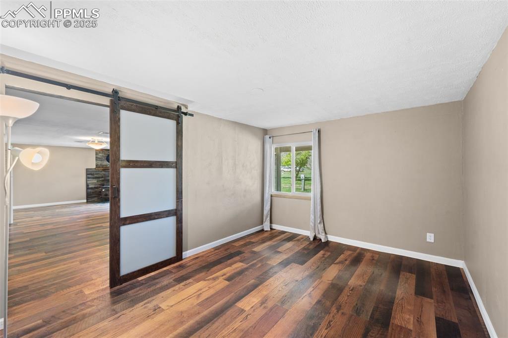 1151 Buttercup Road Elizabeth, CO 80107 - Photo 38 of 45 a view of empty room with wooden floor