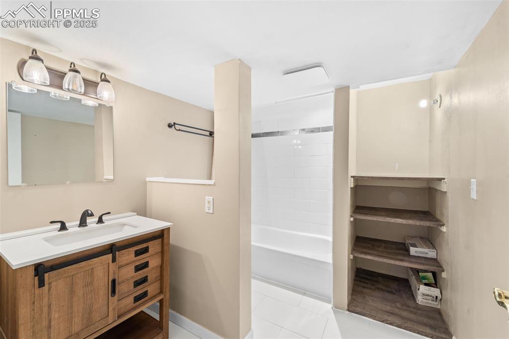 1151 Buttercup Road Elizabeth, CO 80107 - Photo 45 of 45 a bathroom with a sink a mirror and a shower