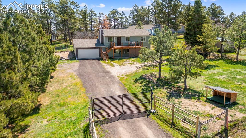 1151 Buttercup Road Elizabeth, CO 80107 - Photo 10 of 45 a view of a patio with table and chairs with wooden fence and plants