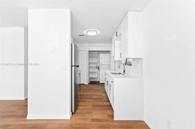 a view of a kitchen from the hallway