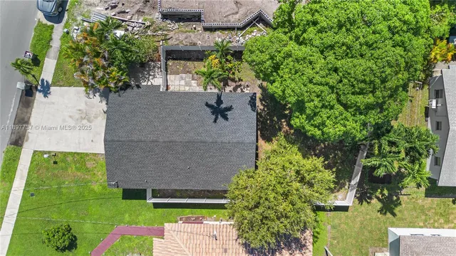 an aerial view of a house with a yard