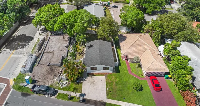 an aerial view of a house with a yard and garden