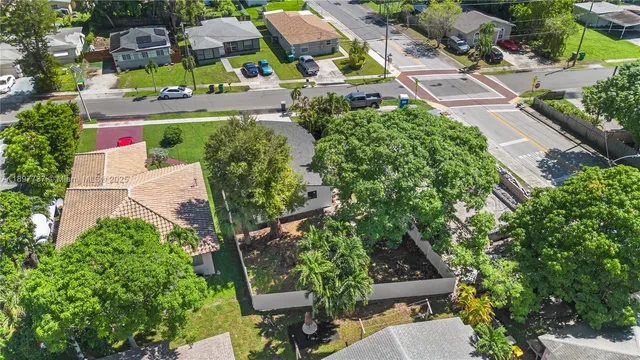 an aerial view of residential houses with outdoor space and street view
