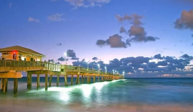 a view of a swimming pool with a table under an umbrella