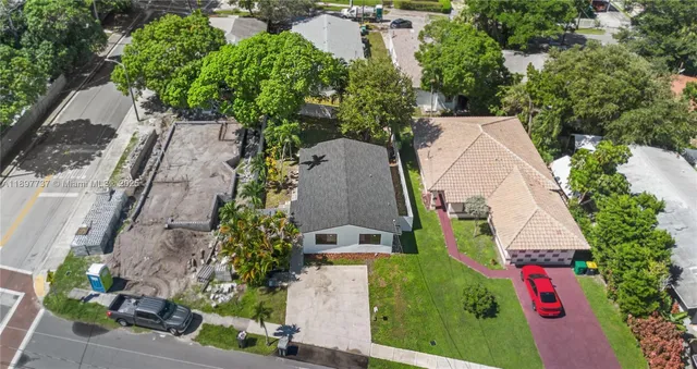 an aerial view of a house with a yard and garden