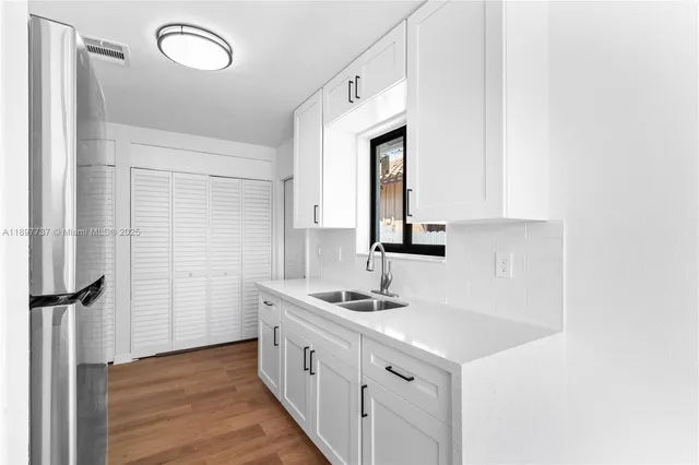 a kitchen with granite countertop a sink and a stove