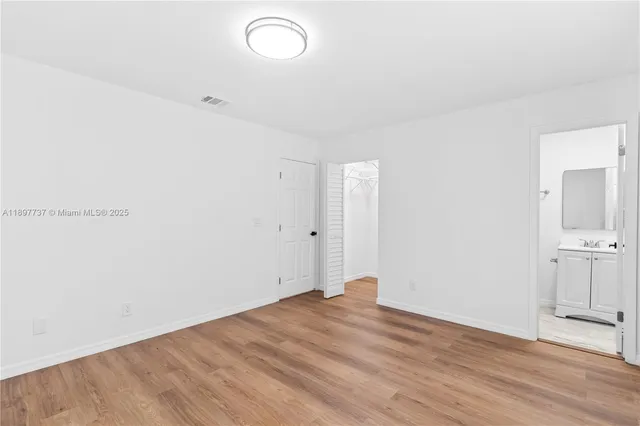 a view of a room with wooden floor